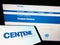 Mobile phone with business logo of US managed care company Centene Corporation on screen in front of webpage.