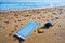 Mobile phone and car keys on beach sand