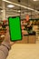 Mobile phone Chroma key for mobile app application. Close up of woman hand holds smart phone with green screen at