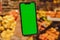 Mobile phone Chroma key for mobile app application. Close up of woman hand holds smart phone with green screen at