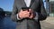 Mobile Phone closeup - Professional business man using smartphone in city