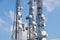 Mobile phone communication antenna tower with satellite dish on blue sky background, Telecommunication tower