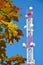 Mobile phone communication radio tv tower, mast, cell microwave antennas and transmitter against the blue sky and trees