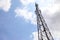 Mobile phone communication tower transmission signal with blue sky and antenna
