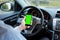 Mobile phone with green screen in car background