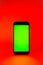 Mobile phone with green screen, smartphone mock up. Red illumination. Flat screen modern smartphone