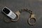 Mobile phone handcuffs asphalt background