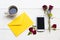 Mobile phone ,hot coffee espresso ,yellow envelope and red rose