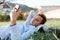 Mobile phone and Internet. A teenage boy lies in the Park on the grass and watches a video on a smartphone