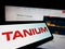 Mobile phone with logo of American cybersecurity company Tanium Inc. on screen in front of business website.