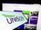 Mobile phone with logo of British trade union UNISON on screen in front of website.