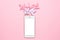 Mobile phone and paper windmill pinwheel on pink background, technology and children toys