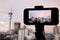 Mobile phone photographing and filming a rainbow in a rain cloud