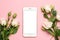 Mobile phone with roses flowers on pink pastel background, women technology concept