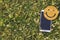 Mobile phone, smart background with a blank black screen on green grass with flowers, with a wooden smiley smile, lit by the