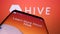 Mobile phone with website of American company Hive Technologies Inc. (Drive Hive) on screen in front of logo.