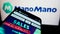 Mobile phone with website of French online marketplace ManoMano (Colibri SAS) on screen in front of logo.