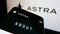 Mobile phone with website of US aerospace company Astra Space Inc. on screen in front of business logo.