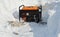 A mobile portable backup generator on the snow after a winter storm. Using a portable generator as an emergency power-supply