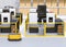 Mobile robots passing CNC robot cells in factory