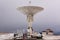 Mobile satellite dish antenna radar station on the dramatic overcast sky background