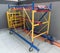 mobile scaffolding for inner interior and outdoor construction work. Platform ladder. Yellow and blue moving tower.