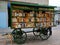 Mobile secondhand bookshop inside a green old-fashioned wagon