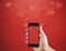 Mobile smart phone, on red background with floating hearts. Valentines, love message and texting concept