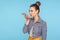 Mobile smart voice technology. Beautiful fashionably dressed woman with hair bun talking to smartphone using virtual assistant