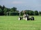 Mobile sprinkler on an empty soccer field on the countryside on the dry summer time