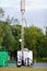 Mobile station, mobile cell tower, 3G, 4G, 5G in park. Concept new wireless technologies, additional telecommunication devices,