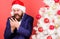 Mobile tariff roaming. Man bearded face wear suit and santa hat hold phone. Congratulate relatives abroad mobile call