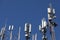 Mobile towers on blue sky background. Many communication equipment