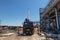 A mobile truck with a lifting boom stands on construction site