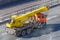 Mobile yellow big crane truck rides on the highway