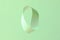 Mobius strip soaring in the air on mint background