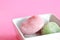 Mochi rice cakes dessert against pink backg