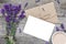 Mock up blank greeting card and envelope with lavender flowers and cup of cappuccino with copy space. top view. flat lay