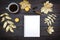 Mock up of a blank notebook page on a dark rustic wooden table with coffee, gold colored autumn leaves and candles for a holiday