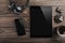 Mock-up blank screen tablet and smartphone, office desk table with headphones, biscuits and coffee cup