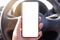 mock up driver hand holding phone in car empty clear screen for text- advertise copy-space background- image