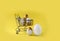 Mock up Easter composition with shopping trolley and  golden decorated eggs on yellow background.