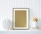 Mock up golden poster frame in interior background with decor