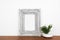 Mock up gray rustic frame with succulent plant on a wood shelf