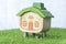 Mock up house on coins stack and grass floor