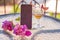 Mock up of mobile screen with glass of wine decorated with fresh bright summer surreal flowers. Feminine flat lay. Copy