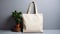 Mock-up of one empty reusable rectangular canvas bag near indoor plant. Eco-friendly shopping bag made of natural material