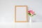 Mock up photo frame with flowers on table