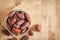 Mock up picture of dates palm fruit in cup on wooden table background. Dates palm fruit dry is snack healthy