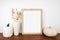 Mock up portrait wooden frame with fall grasses and pumpkin decor on a wood shelf